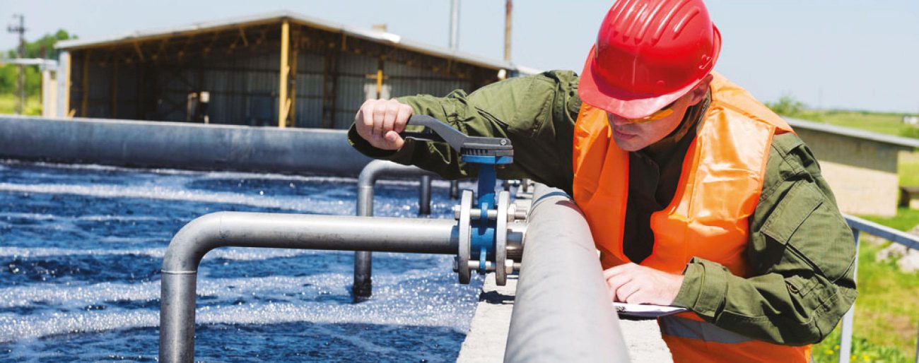 man working on pipes of water treatment plant