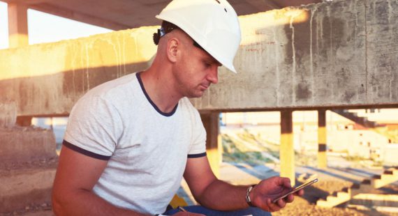 construction worker checking phone app