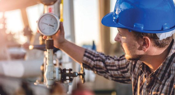 worker checking instrument valve